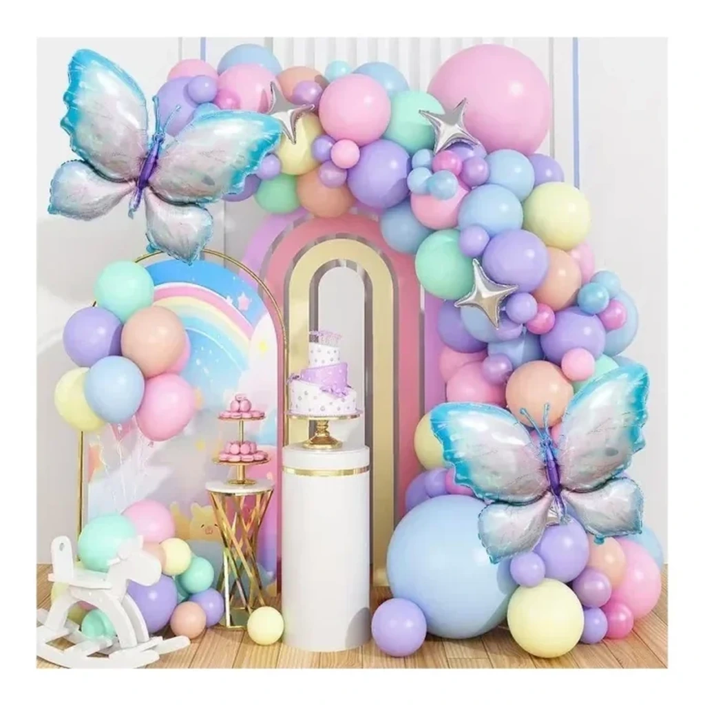 Pastel latex and foil balloons arranged around a birthday party backdrop